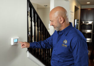 A technician working on a thermostat